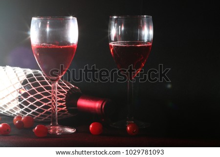 Set of Drink of red wine or grapes cocktail in glass put on table with flash or lighting bokeh on black and dark background