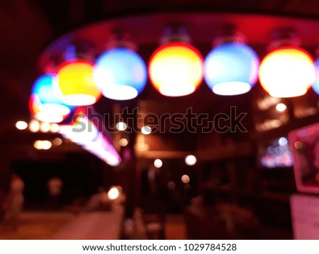 Colorful lights from lamp in the restaurant. Yellow and blue lights color and bokeh. Motion blur. Abstract background.