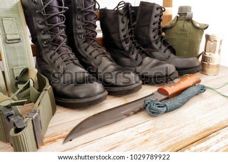 Military pack for soldier,army water canteen ,rope,light,Military combat boots, combat knife ,hat on white wooden background,top view for copy space