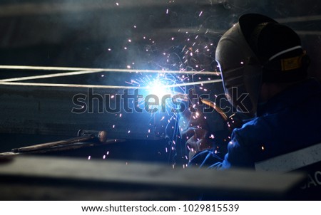 worker in welding mask welding metal construction Royalty-Free Stock Photo #1029815539