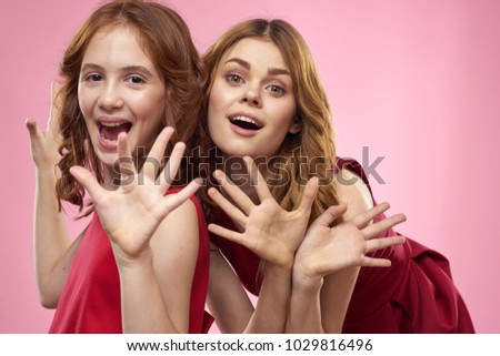  joyful sisters on a pink background.                              