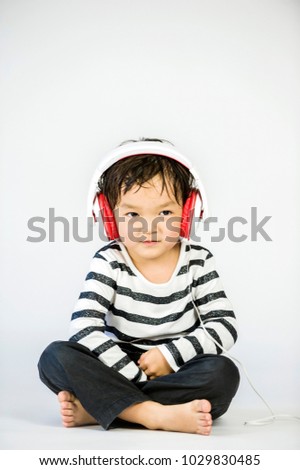 Boy listen to music on a white background