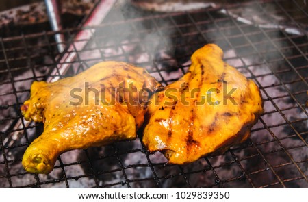 Barbecue Chicken with smoke : Chargrilled chicken on barbecue outdoor,Summer food.