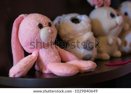 Pink teddy bears on a stick with white bunnies
