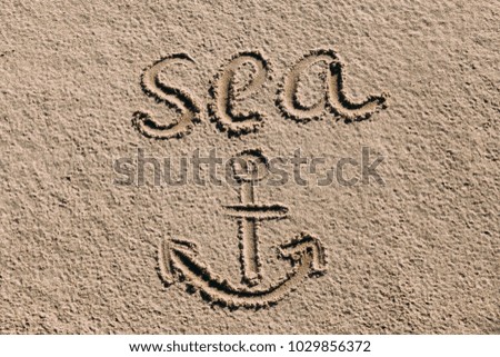 Word "sea" on the sand
