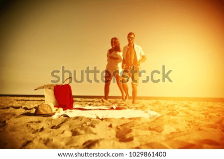 Two lovers on beach and summer golden sunset time. 