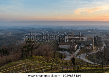 Rosazzo Abbey among the vineyards. Magic colors at sunset.
