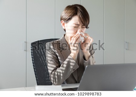 Young asian woman blowing her nose. Nasal inflammation. Hay fever. Royalty-Free Stock Photo #1029898783
