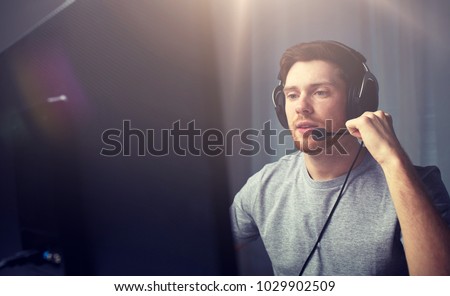 technology, gaming, entertainment, let's play and people concept - young man in headset with pc computer playing game at home and streaming playthrough or walkthrough video Royalty-Free Stock Photo #1029902509