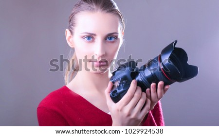 Woman is a professional photographer with camera