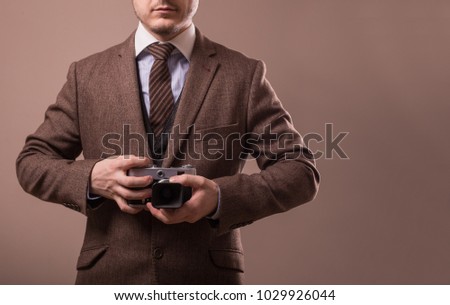 Man with retro camera in tweed vintage dress