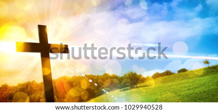 Religious illustration with backlit cross with golden glitter and bokeh and nature landscape background. Horizontal composition