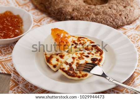Finnish breakfast with mini farmer cheeses Leipajuusto, cloudberry jam, and whipped cream closeup Royalty-Free Stock Photo #1029944473