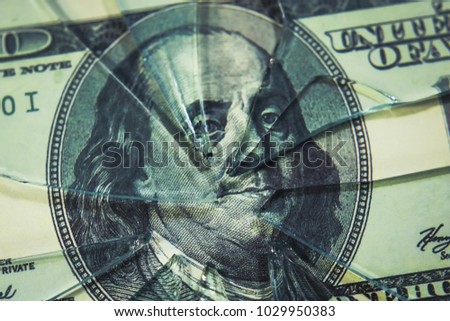 broken glass on the background of a money bill. the concept of inflation and the financial crisis. Royalty-Free Stock Photo #1029950383