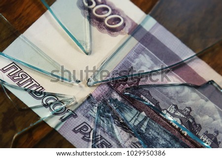 broken glass on the background of a money bill.  five hundred rubles. the concept of inflation and the financial crisis.