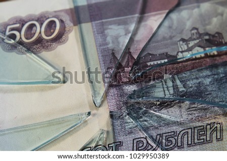 broken glass on the background of a money bill.  five hundred rubles. the concept of inflation and the financial crisis.