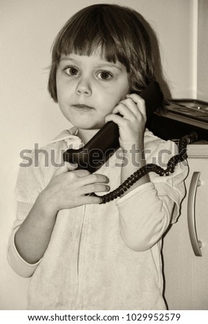 Little girl talking on the old phone