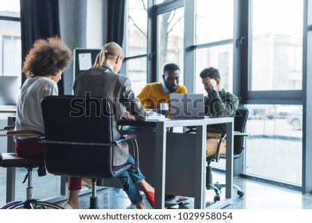 pensive multicultural businesspeople at meeting in office
