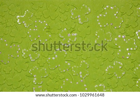 Embossed light green carton paper. Background of shamrock. Extreme closeup