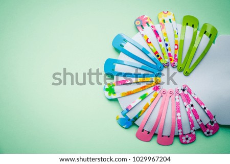set of Hair Clip - nice colourful accessories for girls.elegant style for party.kid colorful hair clipshairpins for girls on soft green  background. Girl fashion. Copy space