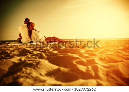 Two lovers on beach and summer golden sunset time. 