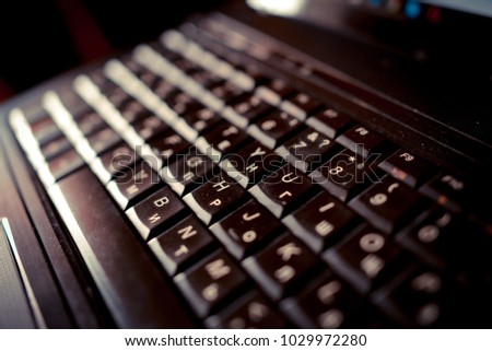 computer keyboard black with white letters of Russian and English alphabet