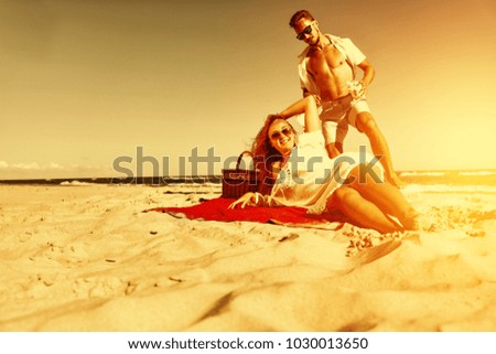 Two lovers on beach and summer golden sunset time. Free space for your text or decoration. 