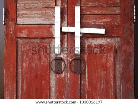 Wooden padlock door and rusty steel loop