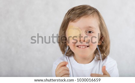 Five years old boy with one eye covered by eye pad and with eye glasses. Royalty-Free Stock Photo #1030016659