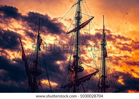 Pirate ship in sunset scenery with seagulls