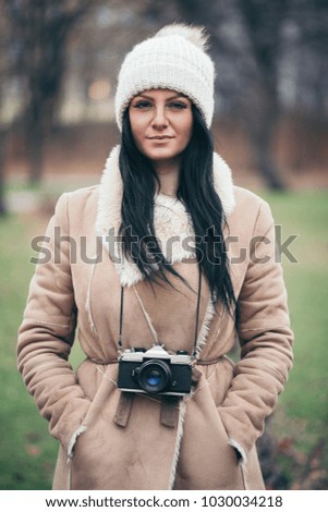 Female photographer taking pictures outdoors with an old vintage camera