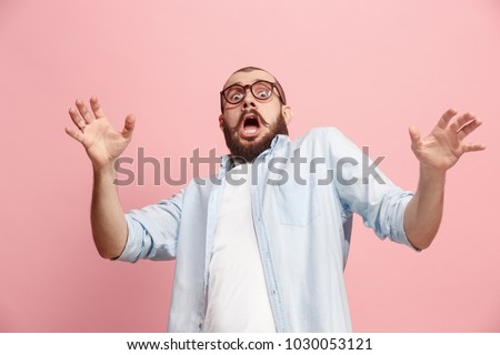 I'm afraid. Fright. Portrait of the scared man. Business man standing isolated on trendy pink studio background. Male half-length portrait. Human emotions, facial expression concept. Front view Royalty-Free Stock Photo #1030053121