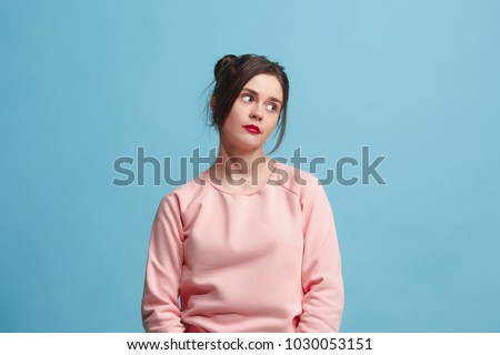 I am tired of everything. Bored woman. Boring, dull, tedious concept. Young pretty caucasian emotional woman. Human emotions, facial expression concept. Studio Isolated on trendy blue background