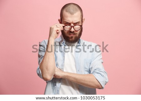 Suspicion. Doubt, mistrust, distrust concept. Doubtful man looking with disbelief expression . Young emotional man. Human emotions, facial expression concept. Studio. Isolated on trendy pink Royalty-Free Stock Photo #1030053175