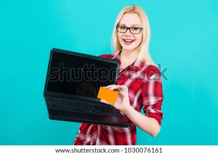 Woman in glasses hold laptop and businesscard