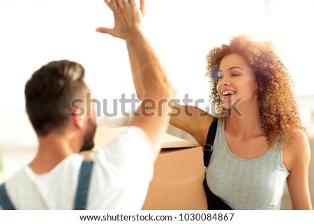 Happy and young couple giving a high five