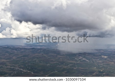 Heavy rain and stormy clouds above rural fields, Italy 