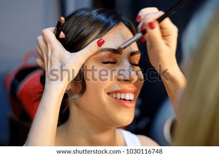Picture of female model and stylist with brush