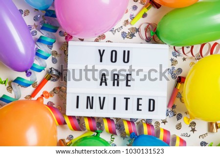 Party celebration background with you are invited message on a lightbox