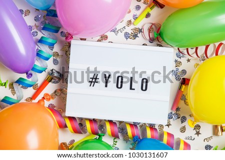Party celebration background with yolo message on a lightbox