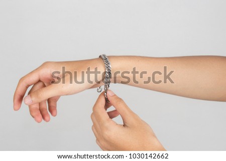 Wearing a stainless steel bracelet on arm isolated on white background.