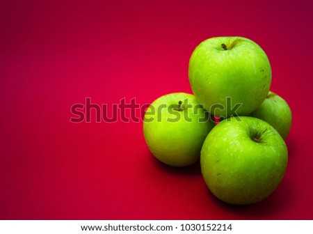 Closeup shot of Green Apple on red background