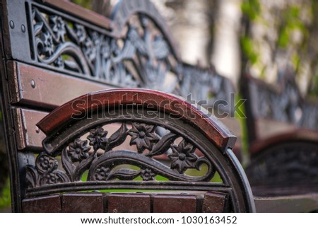 Wooden bench decorated with abstract ornaments in central park of Bucharest
