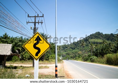 Traffic sign on a road bend