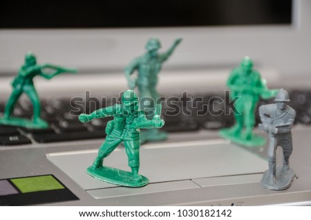 Plastic toy soldiers defend a computer from hacker attacks