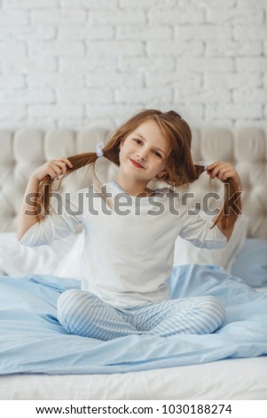 Beautiful little girl in a bed