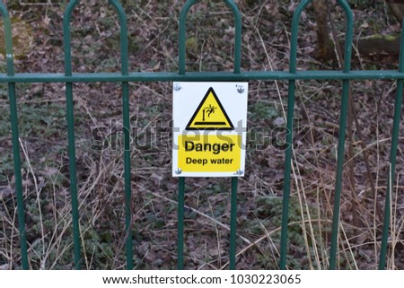 danger deep water sign on railing