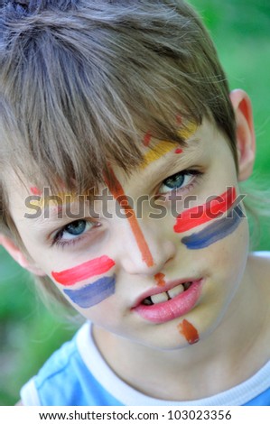 football fan child with painting on his face