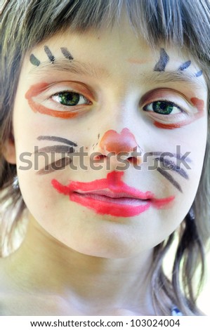 outdoor portrait of a child with his painted face