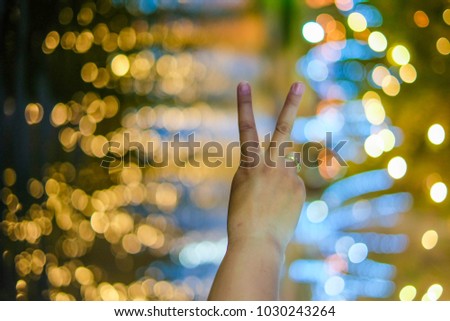 woman hold two fingers on bokeh background, Encouragement to each other.